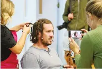  ??  ?? Going: Dan Murphy gets his dreadlocks shorn