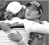  ?? Associated Press ?? ■ Korea's Amy Yang, right, hugs Thailand's Ariya Jutanugarn on the 18th hole after their round on day three of the Ladies Scottish Open on Saturday at Gullane Golf Club, Scotland.