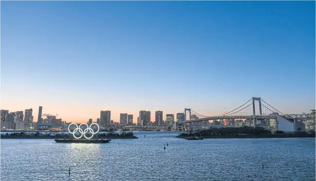  ?? BLOOMBERG ?? The Olympic rings float near the Odaiba island in Tokyo on Tuesday when the 2020 Games were postponed until next year.