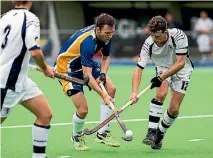  ?? PHOTO: DAVID UNWIN/FAIRFAX NZ ?? Massey’s Mitchell Cronin, centre, and Thomas Walshe of Palmerston North Boys’ High School clash during the opening weekend of the club hockey competitio­n at the twin turfs on Saturday.