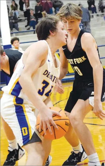  ?? Westside Eagle Observer/MIKE ECKELS ?? After a pair of Tiger defenders try to trap Bulldog Jason Bruffett near the sideline, Bruffett finds a way out and continues to advance on the basket during the Decatur-West Fork junior high boys basketball contest in Decatur Nov. 21. The Bulldogs lost to the Tigers, 32-29.