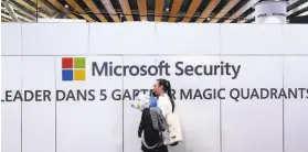  ?? Michel Spingler / Associated Press ?? A woman passes a Microsoft booth at the Cybersecur­ity Conference in France in January. The firm is trying legal action to disrupt a digital crime network.