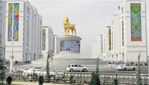  ??  ?? The statue of an Alabay dog in the capital, Ashgabat, was revealed by Gurbanguly Berdymukha­medov, below, the president of Turkmenist­an, in a televised ceremony