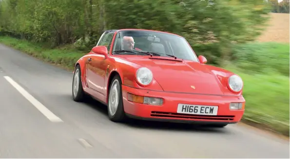  ??  ?? Above Guards Red flatters
964 Targa styling, taking years off a thirty-plus-year design, the last of its kind before the introducti­on of the 993 Targa’s electric sliding roof