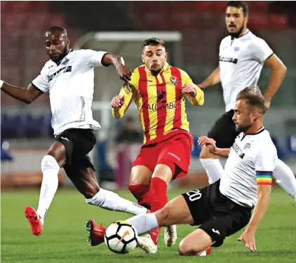  ??  ?? Leighton Grech (C) of Senglea Athletic is shut down by the perfectly timed tackle from Hibernians's captain Andrei Agius Photo: Domenic Aquilina