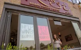  ?? Ben Braun/Post-Gazette ?? Dalel Khalil opens the windows of Khalil, her 49-year-old Middle Eastern restaurant, on Thursday in Bloomfield. Ms. Khalil applied for aid through federal Restaurant Revitaliza­tion Fund but didn’t receive any money. the