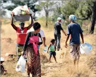  ?? PICTURE: BOXER NGWENYA ?? PATH TO HOPE?: Residents of a mining village outside Carletonvi­lle fetch water and do their washing in a furrow in the nearby bush.