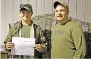  ?? JAMES BENDALL/FOR THE HERALD ?? Sgt. Daniel Baker, right, presents an award at a local charity event, Jake’s Night Out.