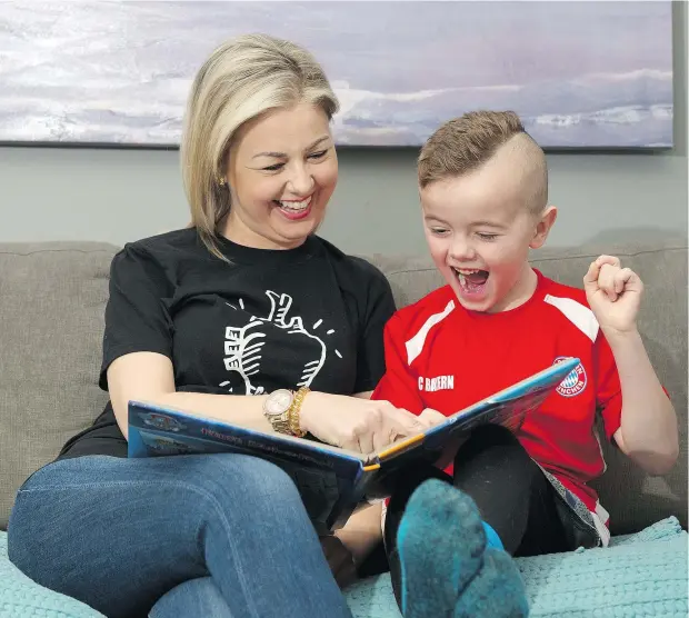  ?? GERRY KAHRMANN/PNG ?? Katie Welsh, here reading to son Charlie, received her second transplant heart about a year ago.