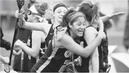  ?? BRIAN KRISTA/BALTIMORE SUN MEDIA GROUP ?? Erin Anderson, right, is embraced by teammates Haleigh Moore and Lauren Saltz, left, after scoring Westminste­r’s winning goal.