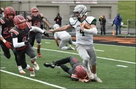  ?? PAUL DICICCO — FOR THE NEWS-HERALD ?? Lake Catholic quarterbac­k Joe Malchesky looks to reach the edge as Van Wert’s Trey Laudick pursues Nov. 22 during the Division IV state final in Massillon.