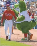  ?? KIM KLEMENT/USA TODAY SPORTS ?? Phillies manager Gabe Kapler talks with the Phillie Phanatic during 2018 spring training.