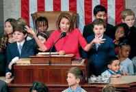  ?? AP ?? House Speaker Nancy Pelosi of California, surrounded by children, speaks from the dais at the US Capitol in Washington after she was sworn in yesterday.
