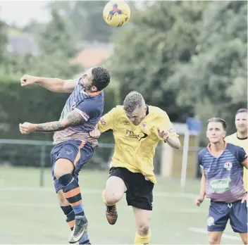  ??  ?? Action from Yaxley’s 4-1 win over Barton Rovers (yellow) in Division One Central of the Southern League.