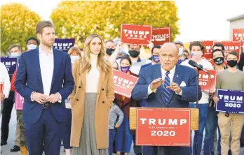  ?? MATTSLOCUM/AP ?? Rudy Giuliani, a lawyer for President Donald Trump, speaks during a news conference on legal challenges to vote counting Nov. 4 in Pennsylvan­ia. At left are Eric Trump, son of President Trump, and his wife, Lara Trump.