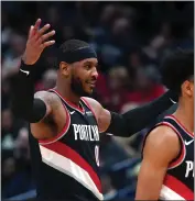  ?? GERALD HERBERT — THE ASSOCIATED PRESS ?? Trail Blazers forward Carmelo Anthony, left, reacts as he walks to the bench with guard Anfernee Simons against the Pelicans in New Orleans on Tuesday.