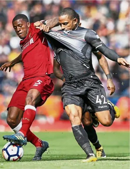  ?? 0.— Reuters ?? Out of my way: Liverpool’s Georginio Wijnaldum (left) vying for the ball with Crystal Palace’s Jason Puncheon in the English Premier League match at Anfield yesterday. Liverpool won 1-