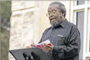  ?? STEPHEN SPILLMAN / FOR AMERICAN-STATESMAN ?? Kenneth Hoke-Witherspoo­n reads the names of slaves sold in Williamson County from 1850 to 1858 during a ceremony at Southweste­rn University in Georgetown on Tuesday. Participan­ts burned pieces of paper with the names of slaves in order to send their...