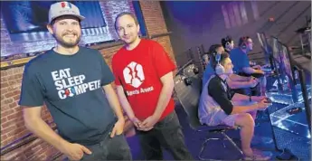  ??  ?? TYLER ENDRES, left, and Paul Ward co-founded eSports Arena in Santa Ana to offer frequent, local competitio­ns and a place where amateur gamers could practice, mingle and play on stage.