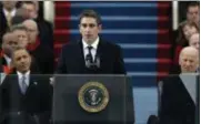  ??  ?? In this Jan. 21, 2013file photo, poet Richard Blanco speaks at the U.S. Capitol in Washington during the inaugurati­on for President Barack Obama, left, and Vice President Joe Biden right. Blanco describes writing the inaugural poem in his new book, ‘For All of Us, One Today: An Inaugural Poet’s Journey.’