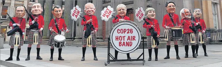  ?? REUTERS ?? Oxfam activists perform in a traditiona­l Scottish pipe band dressed as world leaders at a protest in Glasgow, Scotland, Britain.