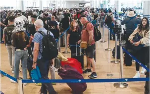  ?? (Avshalom Sassoni/Flash90) ?? TRAVELERS QUEUE at Ben-Gurion Airport the day before Passover last month.