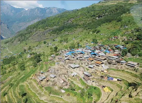  ?? (AFP) ?? Damaged houses are seen from an Indian army helicopter at Archletar Dhading village in Gorkha district in Nepal on May 3. The death toll from an earthquake that ripped through
Nepal will climb ‘much higher’, the government warned May 3, as relief...