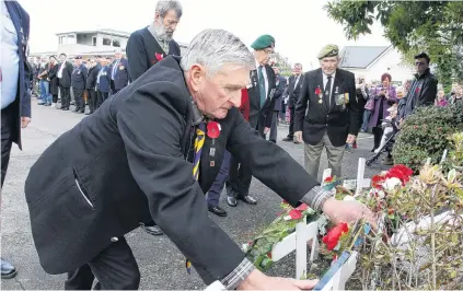  ?? PHOTO: GIORDANO STOLLEY ?? Rememberin­g the fallen . . . Watched by other veterans, Private Pat Blair, a veteran of Malaya and Vietnam, lays a wreath at an Anzac Day service held at the Awarua RSA in Invercargi­ll.