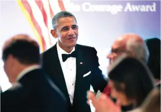  ??  ?? Former US President Barack Obama greets people in the audience after being presented with the 2017 Profile in Courage award during ceremonies at the John F. Kennedy Presidenti­al Library and Museum in Boston. (AP)