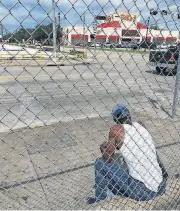  ?? [AP PHOTO] ?? Eric Brian sits on a street Aug. 30 in Houston. “We ain’t got nothing to lose anyway,” said Brian, one of the thousands of the city’s dispossess­ed.