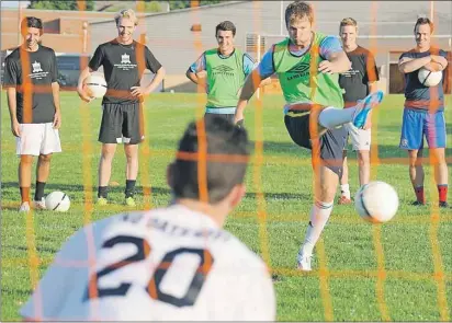  ?? JASON MALLOY/THE GUARDIAN ?? Adam Lowther takes a shot on keeper Liam Bitar Thursday during SoccerStop P.E.I. F.C. practice in Charlottet­own.