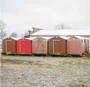  ?? ?? Ice fishing shanties, stored on a lot due to lack of ice, in Put-in-bay. Ice coverage of Lake Erie this year hit record lows. “It don’t freeze like it used to,” one resident said.