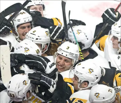  ?? Canadian Press ?? Somewhere in this sea of Penguins is Brandon Tanev after he scored the winning goal in overtime Saturday night to beat the Canadiens 3-2 in Montreal.