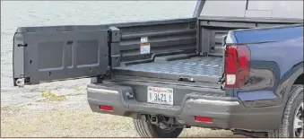  ??  ?? The Ridgeline’s tailgate swings out from the right, or it can be dropped down (it can hold 300 pounds).