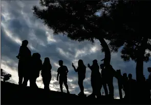  ?? (AP/Julia Nikhinson) ?? People watch as workers start to remove a section of the collapsed Francis Scott Key Bridge late Sunday in Baltimore.