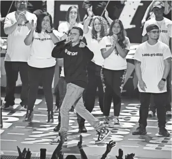  ?? CHRIS PIZZELLO, INVISION/AP ?? Logic performs 1-800-273-8255, named for a suicide prevention hotline, while surrounded by suicide survivors at the MTV Video Music Awards at The Forum on Sunday.