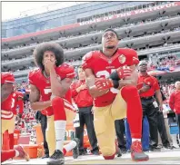  ?? AP PHOTO ?? San Francisco quarterbac­k Colin Kaepernick, left, and safety Eric Reid kneel during the national anthem before an NFL football game against the Dallas Cowboys on Oct. 2, 2016.