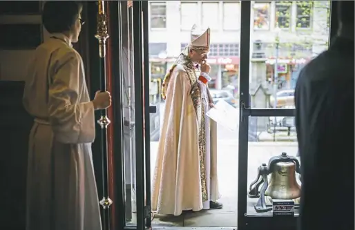  ?? Andrew Rush/Post-Gazette ?? Bishop Dorsey McConnell of the Episcopal Diocese of Pittsburgh prepares for a blessing and rededicati­on service for the tower bells Wednesday at Trinity Cathedral, Downtown. At his feet is a bell found in the church basement that was previously unknown...