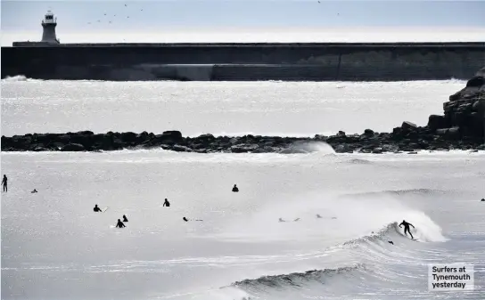  ??  ?? Surfers at Tynemouth yesterday