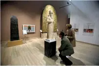  ?? Reuters ?? Participan­ts in the Antiquitie­s Protection Workshop look a King Shalmanese­r III statue, while learning to counter heritage crimes and traffickin­g of artefacts, at the National Museum in Baghdad. —