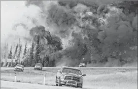  ?? CP PHOTO ?? A wildfire burns through a forest south of Fort McMurray, Alta., on Highway 63 on May 7, 2016. A detailed report into how the Fort McMurray wildfire affected Indigenous communitie­s has found major shortcomin­gs in how authoritie­s worked with First Nations.