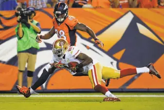  ?? Jack Dempsey / Associated Press ?? The 49ers’ Kenneth Acker intercepts a pass during a preseason game in Denver. Under Tim Lewis’ tutelage, Acker ranks ninth in the NFL in intercepti­ons with three.