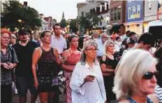  ?? Reuters ?? People stream down the streets of downtown Annapolis during a candleligh­t vigil held on Friday evening rememberin­g the five people killed at the Capital Gazette newspaper.