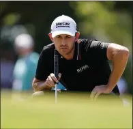  ?? (AP/Brynn Anderson) ?? Patrick Cantlay lines up his shot from the first green during the third round of the Tour Championsh­ip on Saturday at East Lake Golf Club in Atlanta. Cantlay’s 3-under 67 gives him a two-shot lead heading into today’s final round.