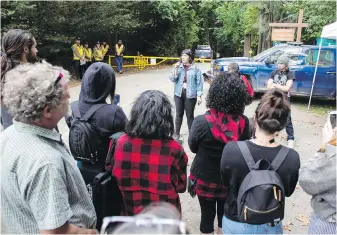  ??  ?? Ashley Mollison of the Alliance Against Displaceme­nt speaks at a rally in defence of homeless campers, at the Goldstream Provincial Park campground gate on Saturday.