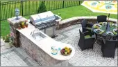  ?? (Dreamstime) ?? Grills, sinks, refrigerat­ors and stone countertop­s are popular outdoor kitchen features.