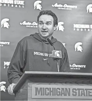  ?? NICK KING/LANSING STATE JOURNAL ?? Michigan State coach Jonathan Smith talks to the media on the first national signing day for college football recruits Wednesday at Spartan Stadium.