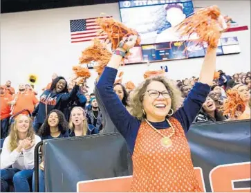  ?? Cal State Fullerton ?? CAL STATE FULLERTON President Mildred García cheers with students at homecoming in 2016. The school, which she took over in 2012, now graduates more Latino students than any other California campus.