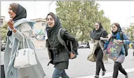  ?? VAHID SALEMI/AP ?? In Tehran today, some women wear tighter clothes with a scarf loosely covering the head.