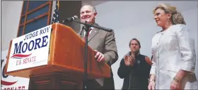  ?? AP/BRYNN ANDERSON ?? Alabama Senate candidate Roy Moore, with his wife, Kayla, speaks Tuesday night in Montgomery after his defeat was assured. But Moore has yet to concede despite a call to winner Doug Jones from President Donald Trump and expression­s of relief by many...